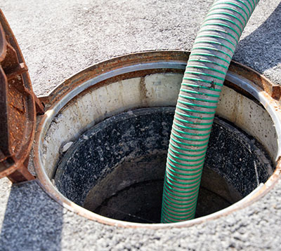 Hose in sewer hole - Residential Plumbing